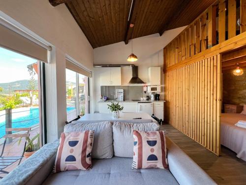 a living room with a large bed and a kitchen at Sossego da Laurinda in Vila Praia de Âncora