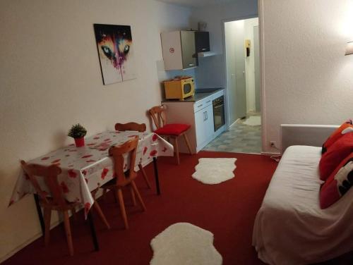 une pièce avec une table et des chaises et une cuisine dans l'établissement Studio montagne 4 personnes, au Corbier