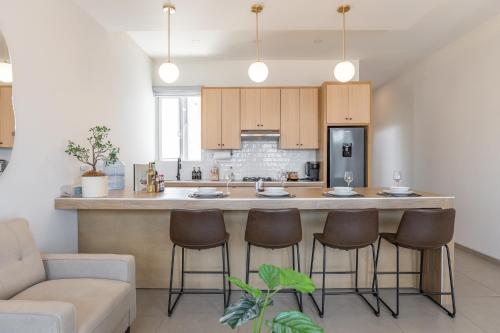 a kitchen with a large island in the middle of a room at New Casa Balandra with Gated Parking at Casas Sanblu in Ensenada