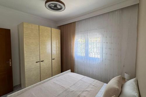 a bedroom with a white bed and a window at Aikaterini's House in Vergia
