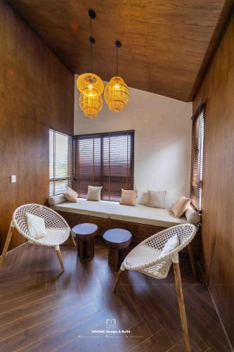 a living room with a couch and two chairs at Tropicana Hồ Tràm - Seashell Villa in Ho Tram