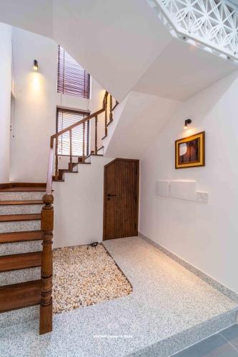 a room with a staircase and a stair case at Tropicana Hồ Tràm - Seashell Villa in Ho Tram