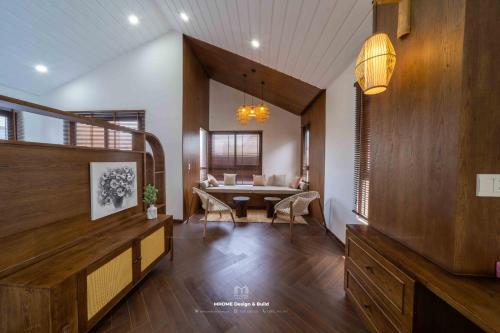 a living room with a table and a dining room at Tropicana Hồ Tràm - Seashell Villa in Ho Tram