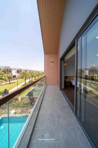 an external view of a house with a swimming pool at Tropicana Hồ Tràm - Seashell Villa in Ho Tram