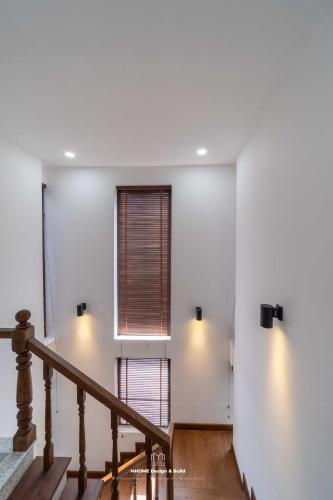a staircase in a house with two windows at Tropicana Hồ Tràm - Seashell Villa in Ho Tram