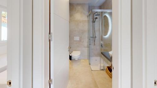 a bathroom with a shower and a toilet at Sunrise by ON Travel in Oliva