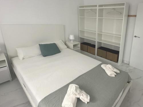 a bedroom with a large bed with shoes on it at Gran Teatro Falla in Cádiz