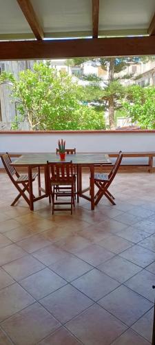 a table and two chairs in a room with a large window at Casa Cecilia in Favignana