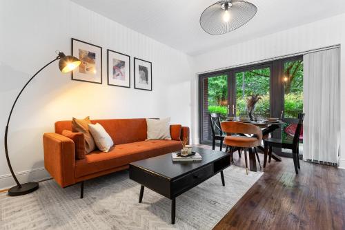 a living room with an orange couch and a table at Modern 2 Bedroom Apartment in Uxbridge London free parking in London
