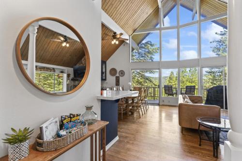 a kitchen and living room with a mirror and a table at Luxe Mountain Retreat Lake Village Close Game Room AC Backs up to trails in Lake Arrowhead