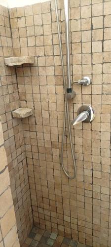 a shower with a hose in a bathroom at Casa Cecilia in Favignana