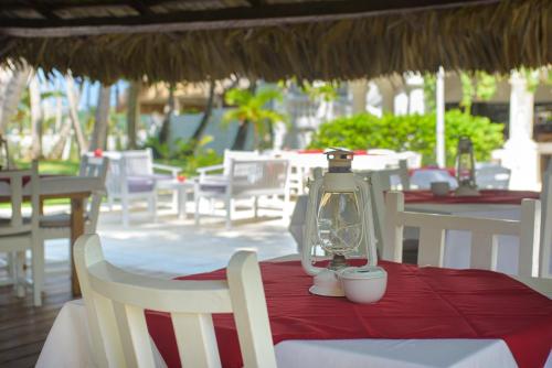 a table with a lantern on top of a table with chairs at Hotel Atlantis in Las Terrenas