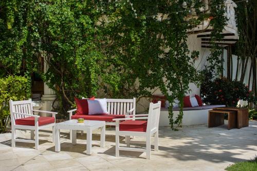 a patio with two chairs and a table and a couch at Hotel Atlantis in Las Terrenas