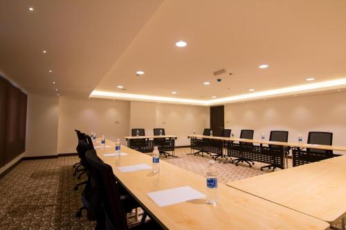 a conference room with a long table and chairs at City Park Hotel Apartments in Muscat
