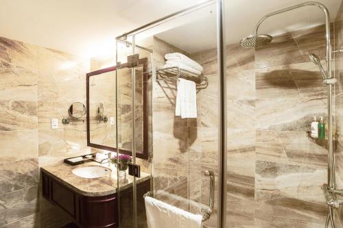 a bathroom with a sink and a shower at Nhat Ha 1 Hotel in Ho Chi Minh City