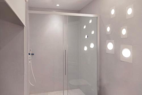 a shower with a glass door in a bathroom at Captain Hook in Hydra