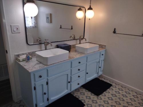 a bathroom with two sinks and a large mirror at Custom Home - Beach close/convenient to everything in Oceanside