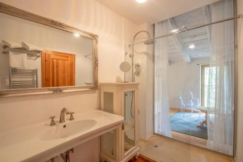 a bathroom with a sink and a mirror at Residence Apolonija Guest House in Sežana
