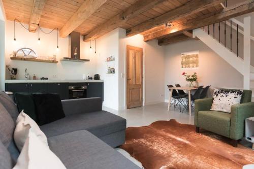 a living room with a couch and a table at Beautiful House in The Middle of Nature in Abcoude