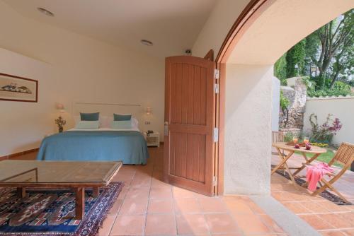 a bedroom with a bed and a table at Hotel Convent de Begur in Begur