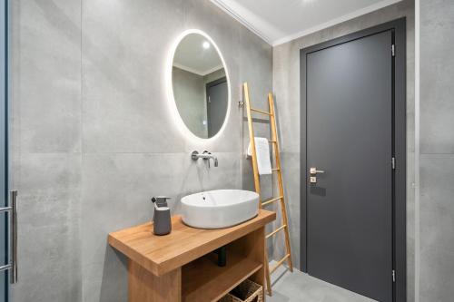 a bathroom with a sink and a mirror at George Studios in Yenion