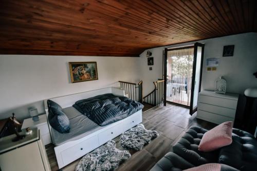 a bedroom with a bed and a living room at Garden of Eden in Mandićevac