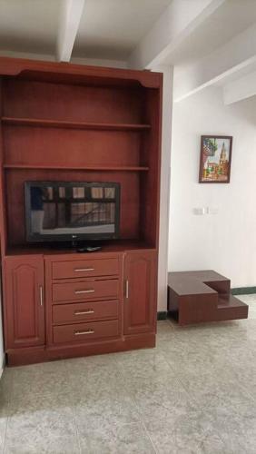 a large wooden cabinet with a television in a room at apartment in neiva goliat 102 in Neiva