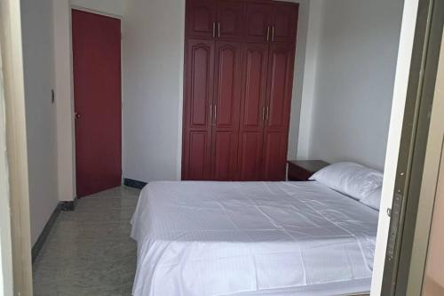 a bedroom with a bed and a red door at apartment in neiva goliat 102 in Neiva