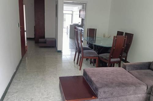a living room with a couch and a table and chairs at apartment in neiva goliat 102 in Neiva
