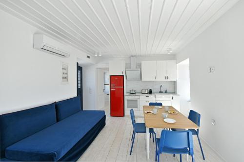 a living room with a blue couch and a table at Captain Hook in Hydra