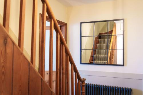 a mirror on the wall next to a stairway at Castlehaw View in Sedbergh