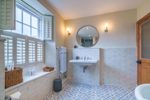 a bathroom with a sink and a mirror at Castlehaw View in Sedbergh