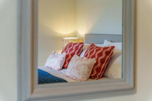 a mirror reflection of a bed with pillows on it at Castlehaw View in Sedbergh