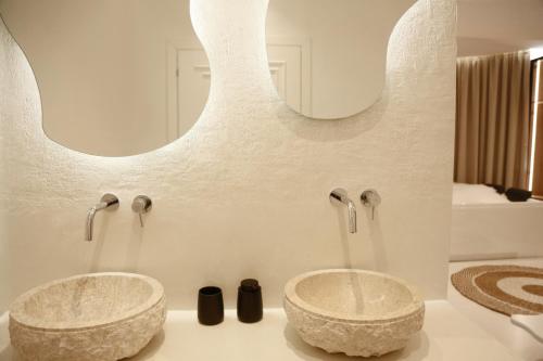 two sinks in a bathroom with two faucets at Foga Hebrus in Ksamil
