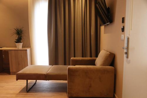 a living room with a couch and a window at Foga Hebrus in Ksamil