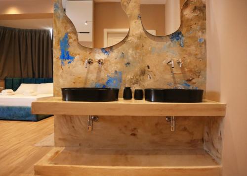 a bathroom with two sinks and a mirror at Foga Hebrus in Ksamil