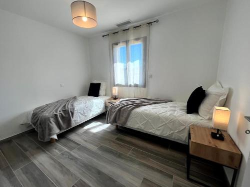a bedroom with a bed and a desk and a window at Villa L'Olivier in Vallon-Pont-dʼArc