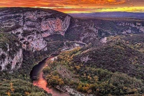 an aerial view of a canyon with a river at Villa L'Olivier in Vallon-Pont-dʼArc