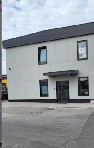 a white building with a black roof at Betooni Stay in Tartu