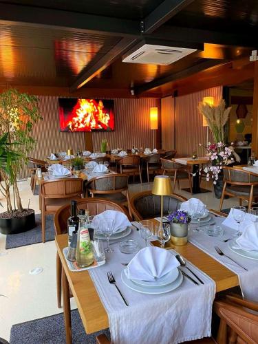 a dining room with a table with plates and napkins at Swiss Plus Hotel in Bihać