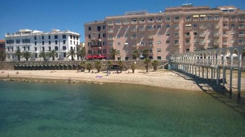a body of water next to buildings and a beach at Il Giardinetto Guest House in Civitavecchia
