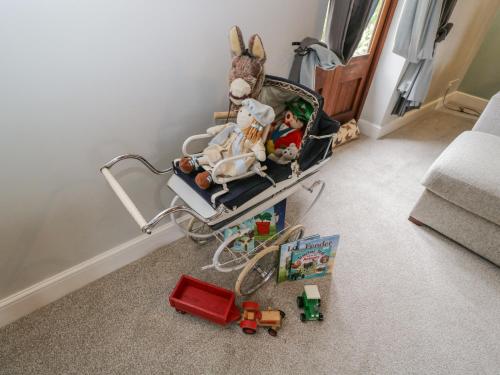 a childs stroller with toys in a room at The Old Byre in Salisbury