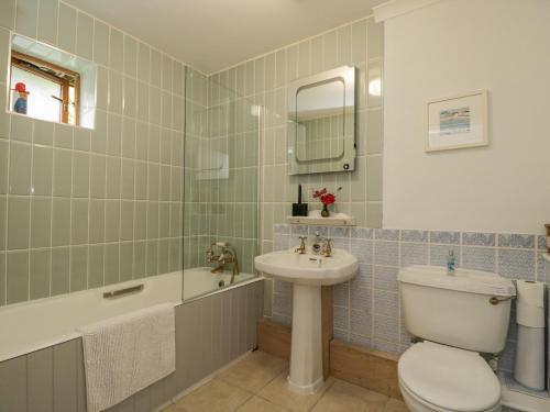 a bathroom with a toilet and a sink and a tub at The Old Byre in Salisbury