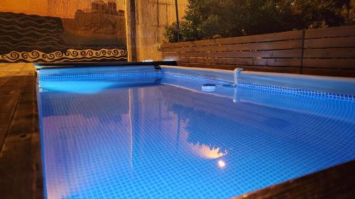 a large swimming pool with blue tiles on it at Hostel Center in Ulcinj