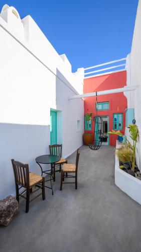 a patio with a table and chairs in a building at Sophia Luxury Suites in Imerovigli