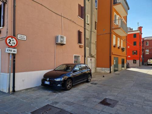 a car parked on a street next to a building at Venezia Beach in Chioggia