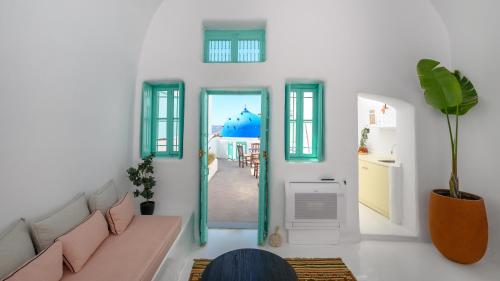 a living room with a couch and a hallway at Sophia Luxury Suites in Imerovigli