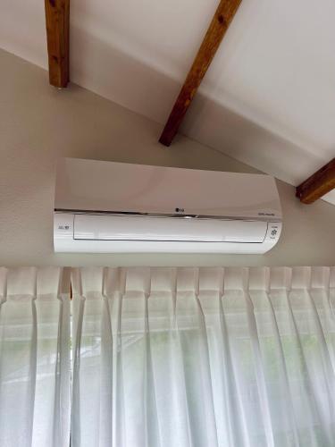 a tv sitting on top of a ceiling at Luxe Boshuisje met Privé Wellness & Jacuzzi op de Veluwe in Ermelo