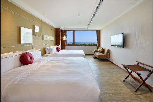 a hotel room with two beds and a window at Shiny Ocean Hotel in Hualien City