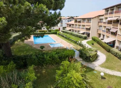 une vue aérienne d'un immeuble avec piscine dans l'établissement Studio du port avec terrasse, parking privatif, piscine dans résidence , wifi, ménage compris, à Andernos-les-Bains